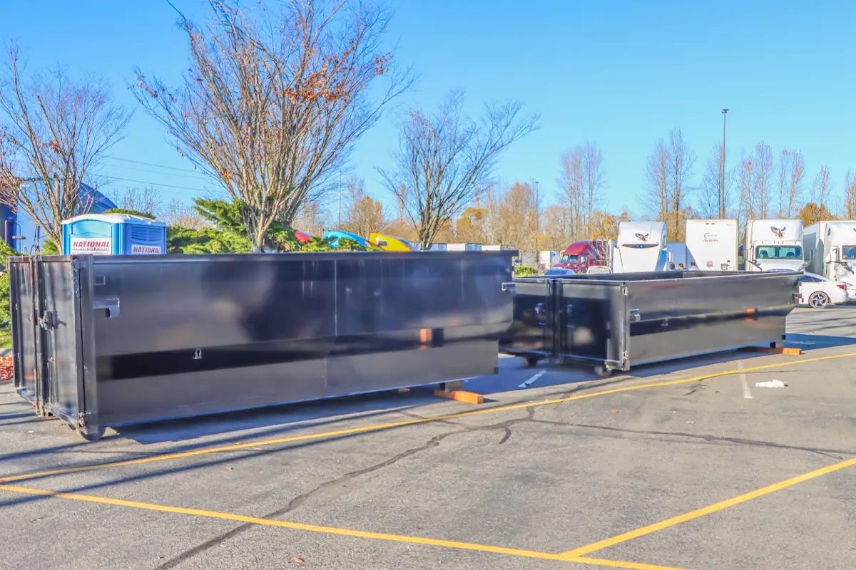 Professional dumpster rental service with roll-off container on residential driveway in Blacklick Estates